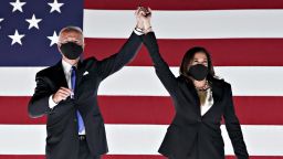Former Vice President Joe Biden, Democratic presidential nominee, left, and Senator Kamala Harris, Democratic vice presidential nominee, wear protective masks while holding hands outside the Chase Center during the Democratic National Convention in Wilmington, Delaware, U.S., on Thursday, Aug. 20, 2020. 