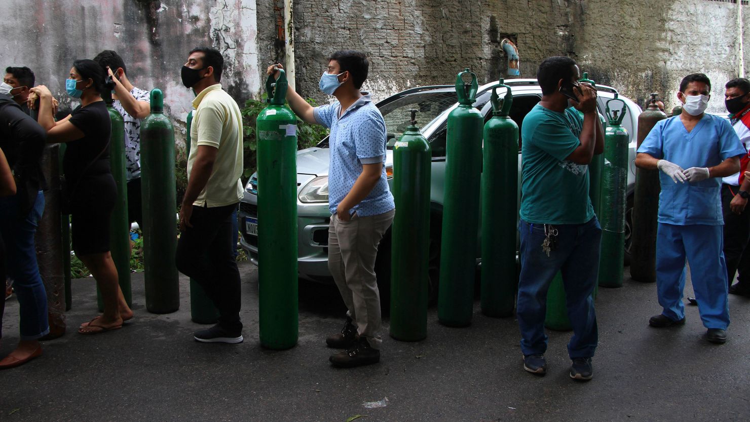 Family members of patients hospitalized with Covid-19 line up with empty oxygen tanks in an attempt to refill them in Manaus, Amazonas state, Brazil on January 15