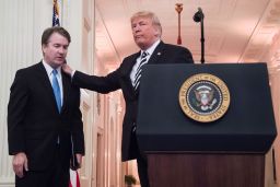 Trump pats Associate Justice of the US Supreme Court Brett Kavanaugh on the back during a ceremonial swear-in at the White House in Washington, DC, on October 8, 2018. 