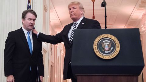 Trump pats Associate Justice of the US Supreme Court Brett Kavanaugh on the back during a ceremonial swear-in at the White House in Washington, DC, on October 8, 2018. 