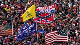 In this January 6, 2021 photo, supporters listen as President Donald Trump speaks during a rally in Washington that preceded the deadly assault on the US Capitol by his supporters.