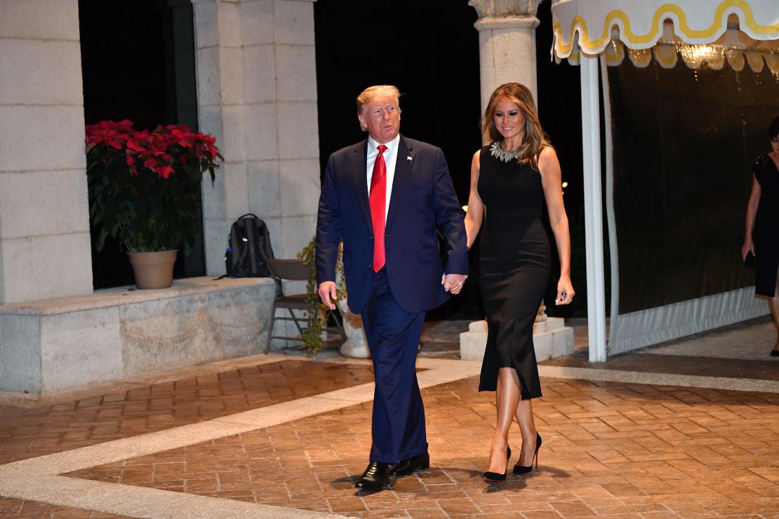 US President Donald Trump and First Lady Melania Trump arrive for a Christmas Eve dinner with his family at Mar-A-Lago in Palm Beach, Florida.