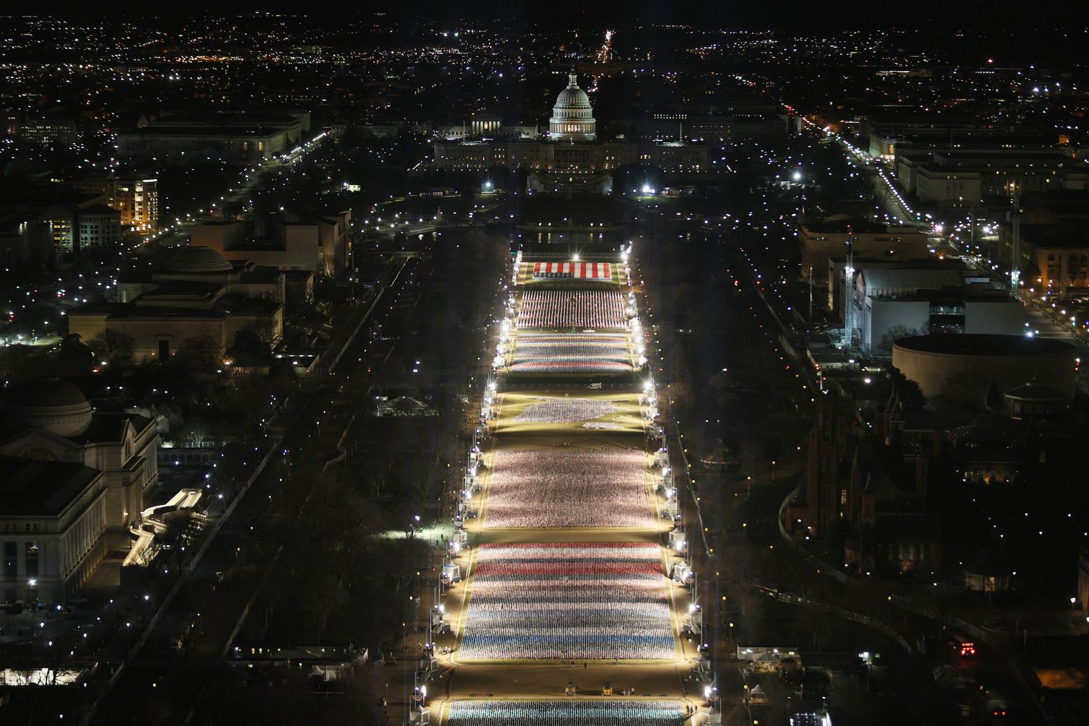 American flags are illuminated on the National Mall.