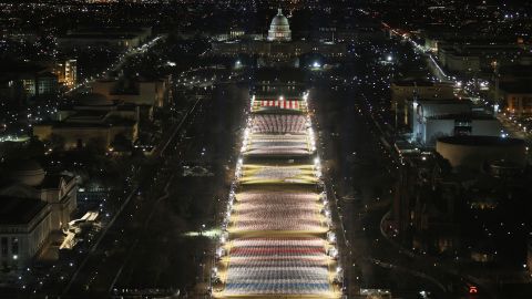 American flags are illuminated on the National Mall.