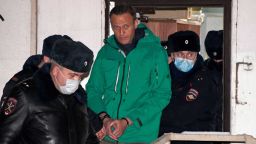 Opposition leader Alexei Navalny is escorted out of a police station on January 18, 2021, in Khimki, outside Moscow, following the court ruling that ordered him jailed for 30 days. - Kremlin critic Alexei Navalny on Monday urged Russians to stage mass anti-government protests during a court hearing after his arrest on arrival in Moscow from Germany. (Photo by Alexander NEMENOV / AFP) (Photo by ALEXANDER NEMENOV/AFP via Getty Images)