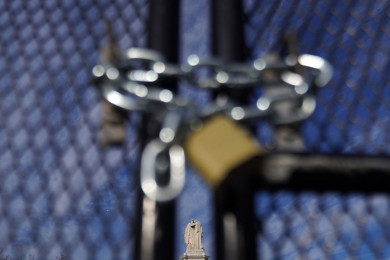 The Peace Monument is seen behind a fence on the grounds of the US Capitol.