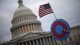 Supporters of U.S. President Donald Trump fly a U.S. flag with a symbol from the group QAnon as they gather outside the U.S. Capitol January 06, 2021 in Washington, DC. Congress will hold a joint session today to ratify President-elect Joe Biden's 306-232 Electoral College win over President Donald Trump. A group of Republican senators have said they will reject the Electoral College votes of several states unless Congress appointed a commission to audit the election results. (Photo by Win McNamee/Getty Images)