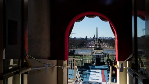 Media members practice camera positions at the entrance to the inauguration stage.