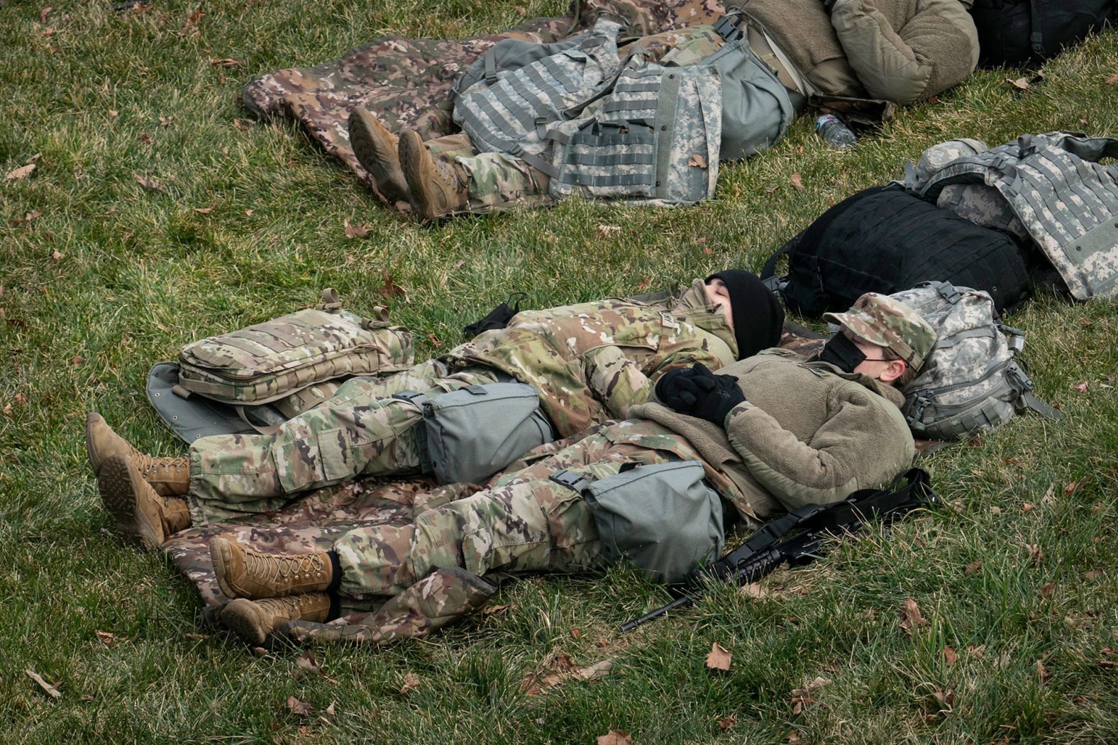 Members of the National Guard rest outside of the US Capitol on the day before the inauguration.