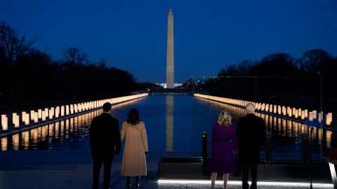 With the Washington Monument in the background, President-elect Joe Biden with his wife Jill Biden and Vice President-elect Kamala Harris with her husband Doug Emhoff listen as Yolanda Adams sings "Hallelujah" during a COVID-19 memorial, with lights placed around the Lincoln Memorial Reflecting Pool, Tuesday, Jan. 19, 2021, in Washington. (AP Photo/Evan Vucci)