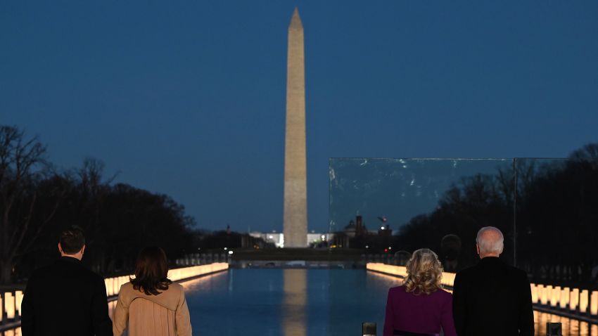 US Vice President-elect Kamala Harris (2nd L) with husband Douglas Emhoff and US President-elect Joe Biden (R) with wife Dr. Jill Biden watch as a Covid-19 Memorial is lighted at the Lincoln Memorial in Washington, DC, on January 19, 2021 to honor the lives of those lost to Covid-19. (Photo by JIM WATSON / AFP) (Photo by JIM WATSON/AFP via Getty Images)