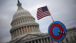 WASHINGTON, DC - JANUARY 06: Supporters of U.S. President Donald Trump fly a U.S. flag with a symbol from the group QAnon as they gather outside the U.S. Capitol January 06, 2021 in Washington, DC. Congress will hold a joint session today to ratify President-elect Joe Biden's 306-232 Electoral College win over President Donald Trump. A group of Republican senators have said they will reject the Electoral College votes of several states unless Congress appointed a commission to audit the election results. (Photo by Win McNamee/Getty Images)