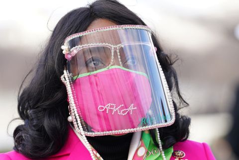 US Rep. Terri Sewell wears a face shield after arriving at the inauguration. Her mask references Alpha Kappa Alpha, Harris' sorority.