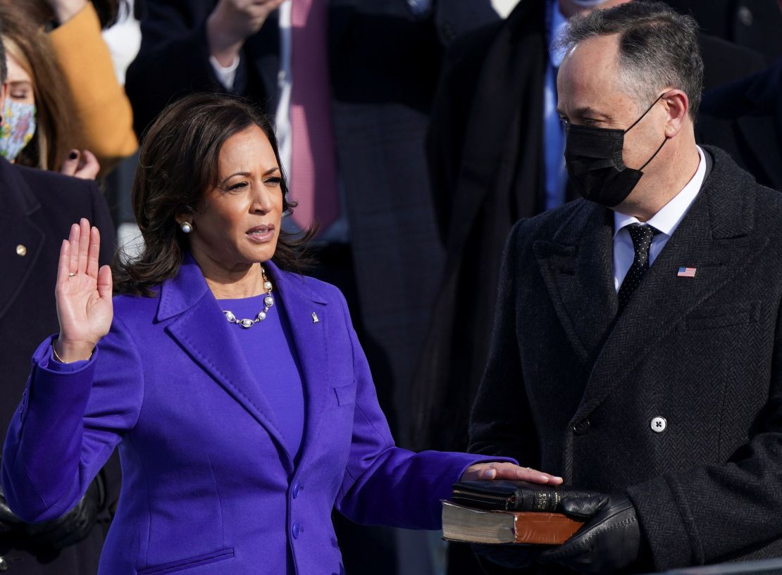Kamala Harris is sworn in as her spouse Doug Emhoff holds two Bibles. 