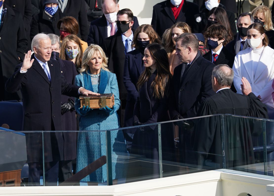 Joe Biden is sworn in as the 46th President of the United States as his wife Jill Biden holds a Bible on the West Front of the US Capitol.