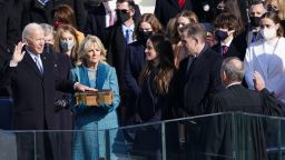 Joe Biden is sworn in as the 46th President of the United States as his wife Jill Biden holds a bible on the West Front of the U.S. Capitol in Washington, U.S., January 20, 2021. REUTERS/Kevin Lamarque
