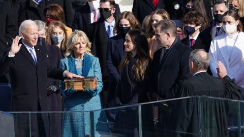 Joe Biden is sworn in as the 46th President of the United States as his wife Jill Biden holds a Bible on the West Front of the US Capitol.