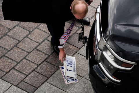 Officials transfer motorcade license plates ahead of the inauguration.