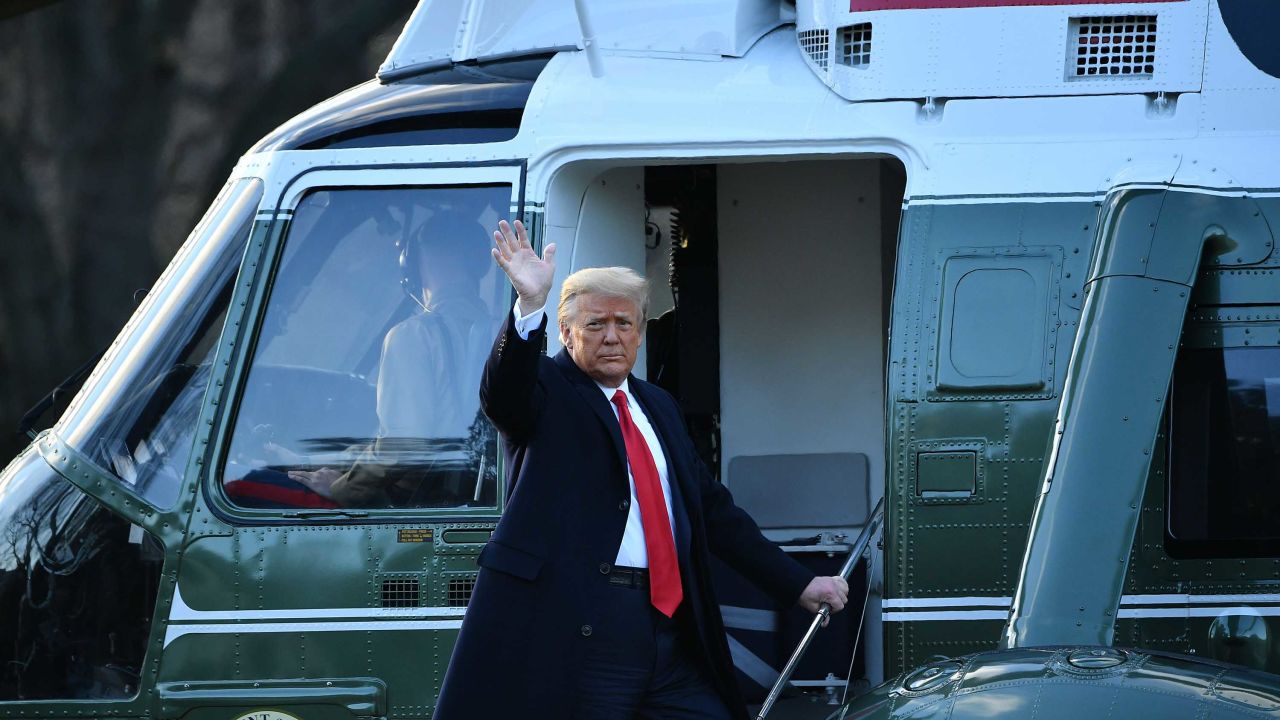 Trump waves as he boards Marine One.