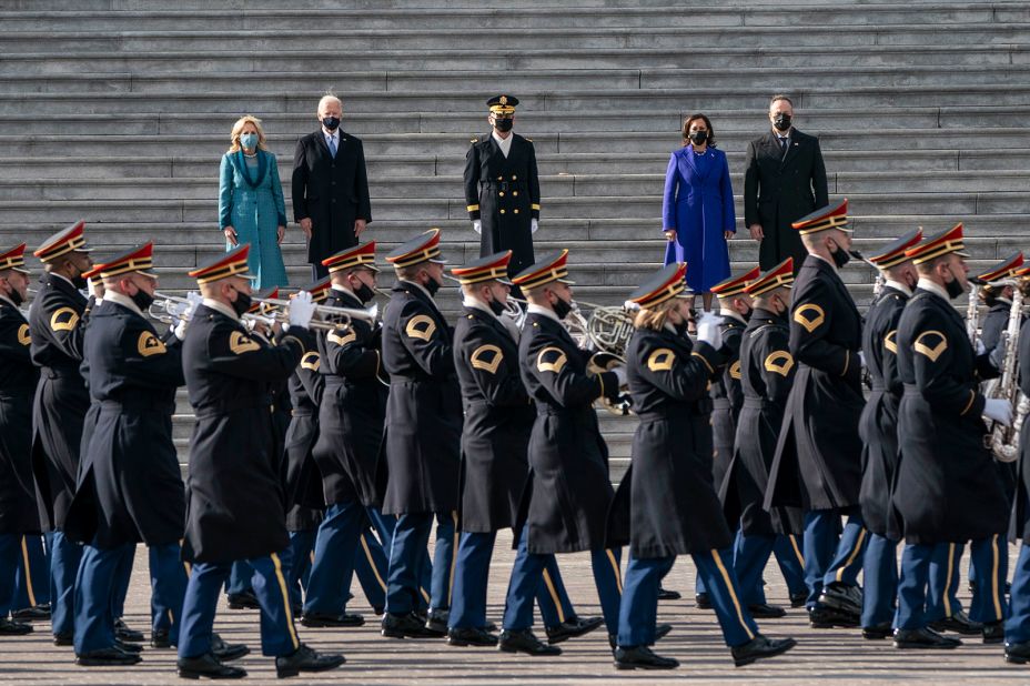 A band parades past the new president and vice president.