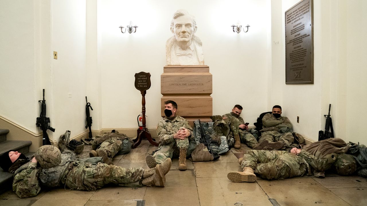 Members of the National Guard rest in the U.S. Capitol.