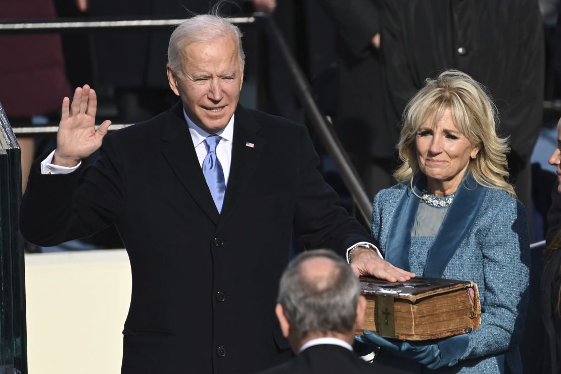 Joe Biden is sworn in as the 46th president of the United States by Chief Justice John Roberts as Jill Biden holds the Bible. 