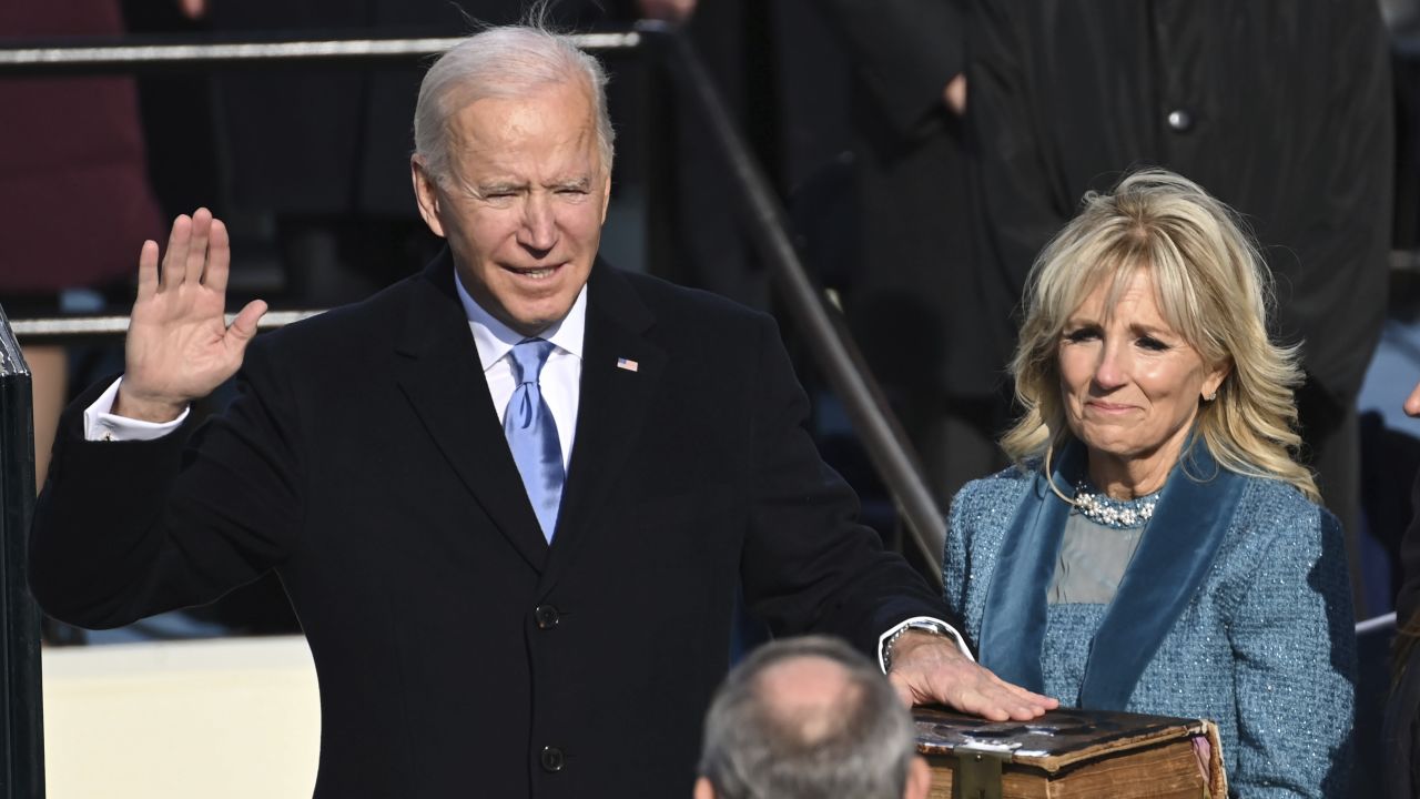 Joe Biden is sworn in as the 46th president of the United States by Chief Justice John Roberts as Jill Biden holds the Bible.