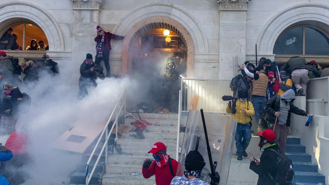 Police use tear gas as pro-Trump supporters riot and breach the building.
