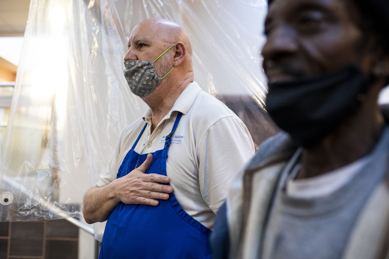 Bob Garrett stands for the Pledge of Allegiance while watching the inauguration in Harrisburg, Pennsylvania. Garrett, a sexton at the Market Square Presbyterian Church, hosted a watch party for the homeless.