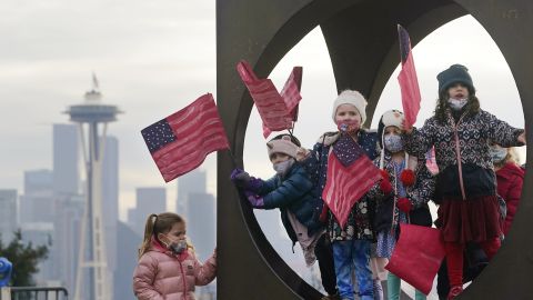 Members of the Children's Workshop, an arts and science preschool in Seattle, pause in a sculpture while walking with flags they made to celebrate the inauguration.