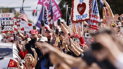 Trump supporters wave to Trump as he returns to his Mar-a-Lago estate in Florida.