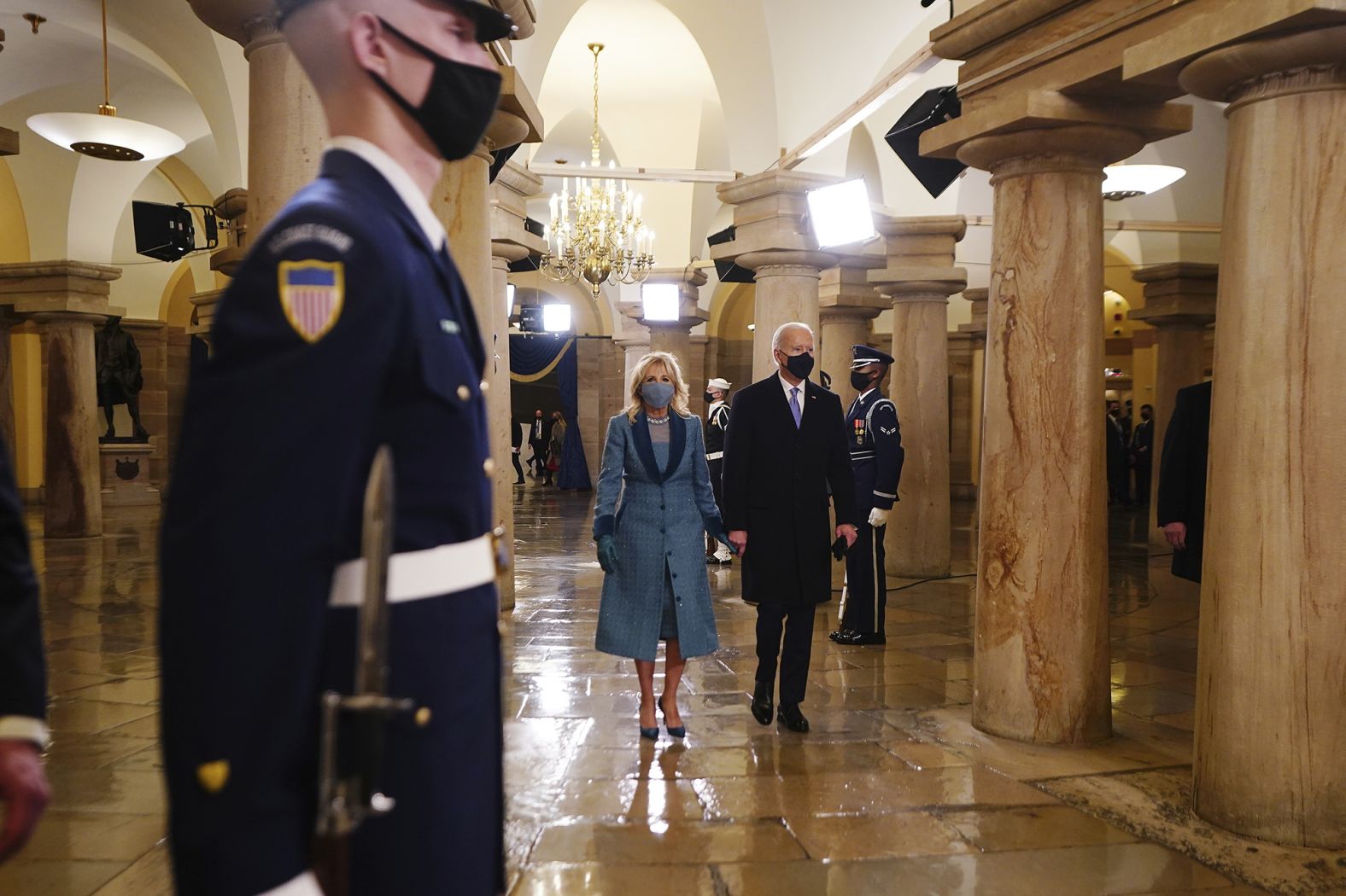 The Bidens walk inside the Capitol.