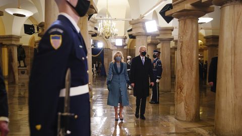 The Bidens walk inside the Capitol.