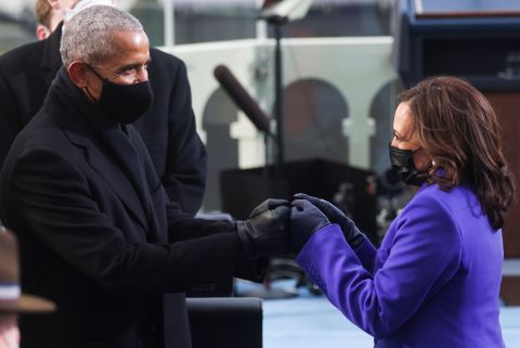 Harris greets former President Obama before the ceremony.