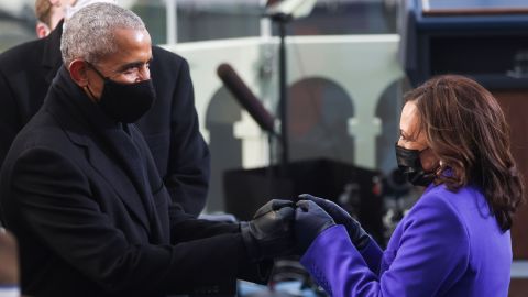 Harris greets former President Obama before the ceremony.