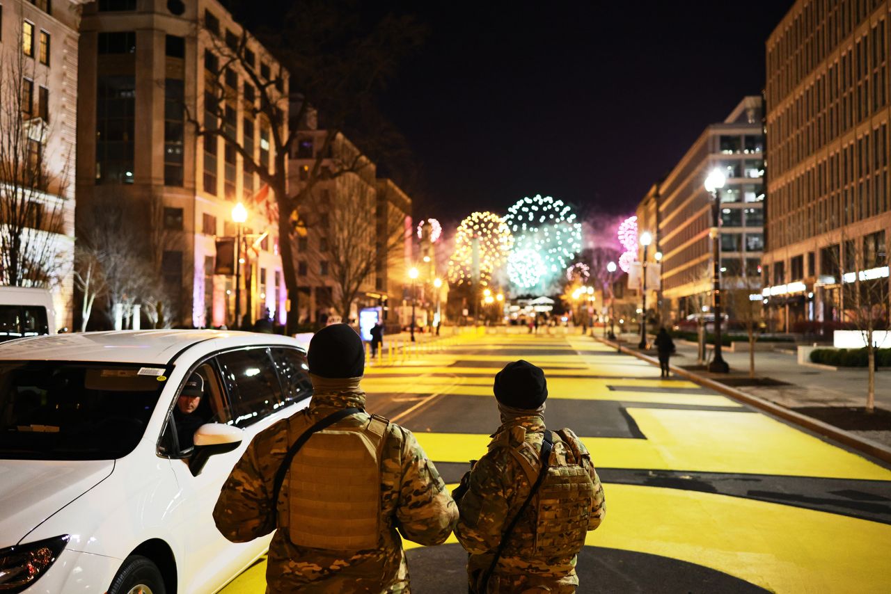 National Guard members watch the fireworks from Black Lives Matter Plaza.