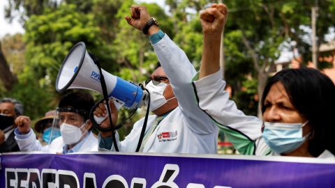 Health workers protest while going on an indefinite strike as they demand a better national health budget and access to vaccines, in Lima, Peru on January 13.