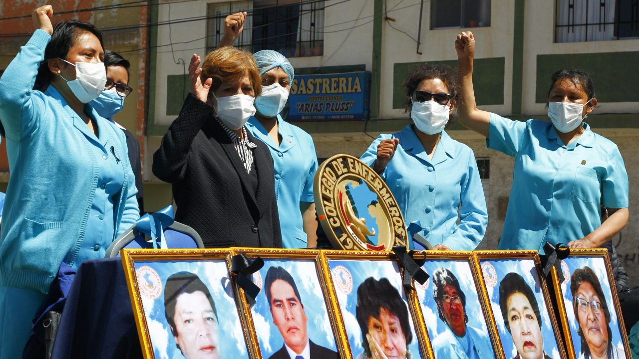 Health workers in the highland city of Puno in the Andes, protest with pictures of their co-workers who died during the pandemic in August.