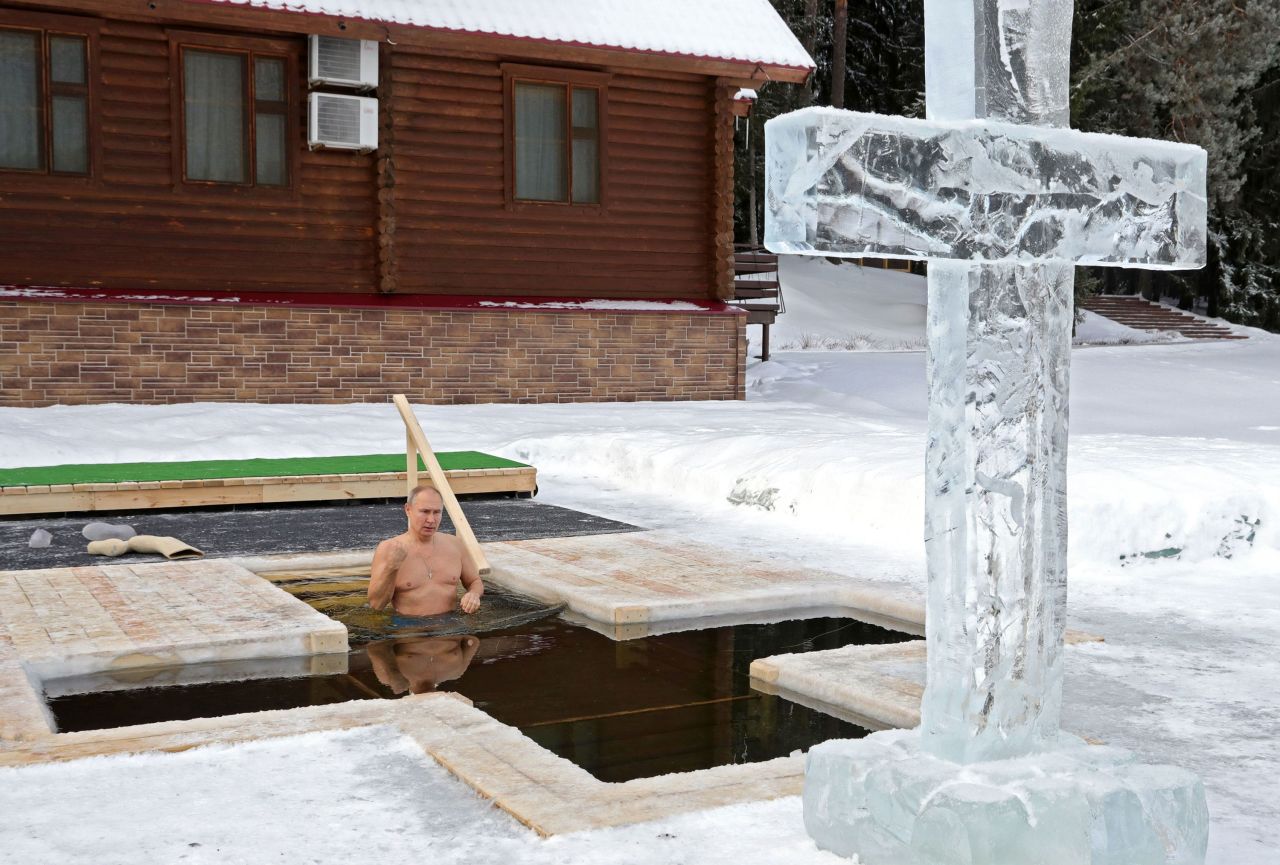 Russian President Vladimir Putin crosses himself as he plunges into icy waters in Moscow during the Epiphany holiday on Tuesday, January 19.