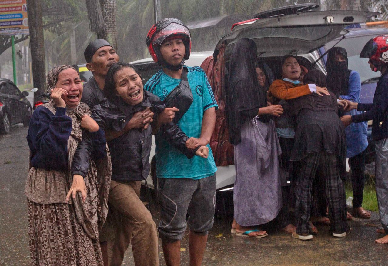 People react as the body of a relative is retrieved from a building's ruins in Mamuju, Indonesia, on Friday, January 15. <a href="https://www.cnn.com/2021/01/16/asia/indonesia-earthquake-search-intl-hnk/index.html" target="_blank">A 6.2 magnitude earthquake</a> shook Indonesia's Sulawesi island just after midnight, toppling buildings, triggering landslides and killing dozens of people.