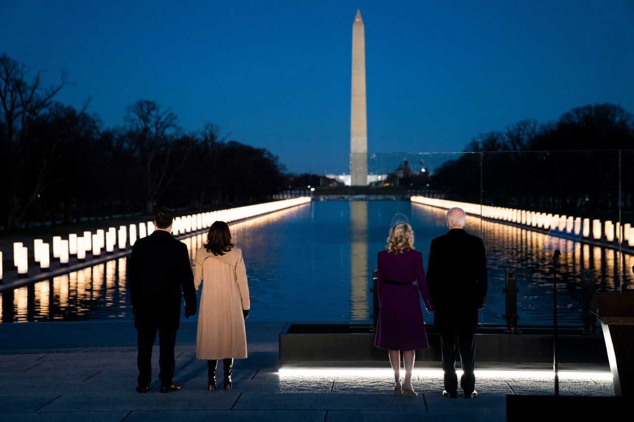 Joe Biden, Kamala Harris and their spouses face the Washington Monument while attending a <a href="https://www.cnn.com/politics/live-news/biden-inauguration-dc-security-01-19-21/h_4e72c7d0832d0f82653410c80f08c00b" target="_blank">Covid-19 memorial</a> Tuesday, January 19, that paid tribute to Americans who have died because of the pandemic.