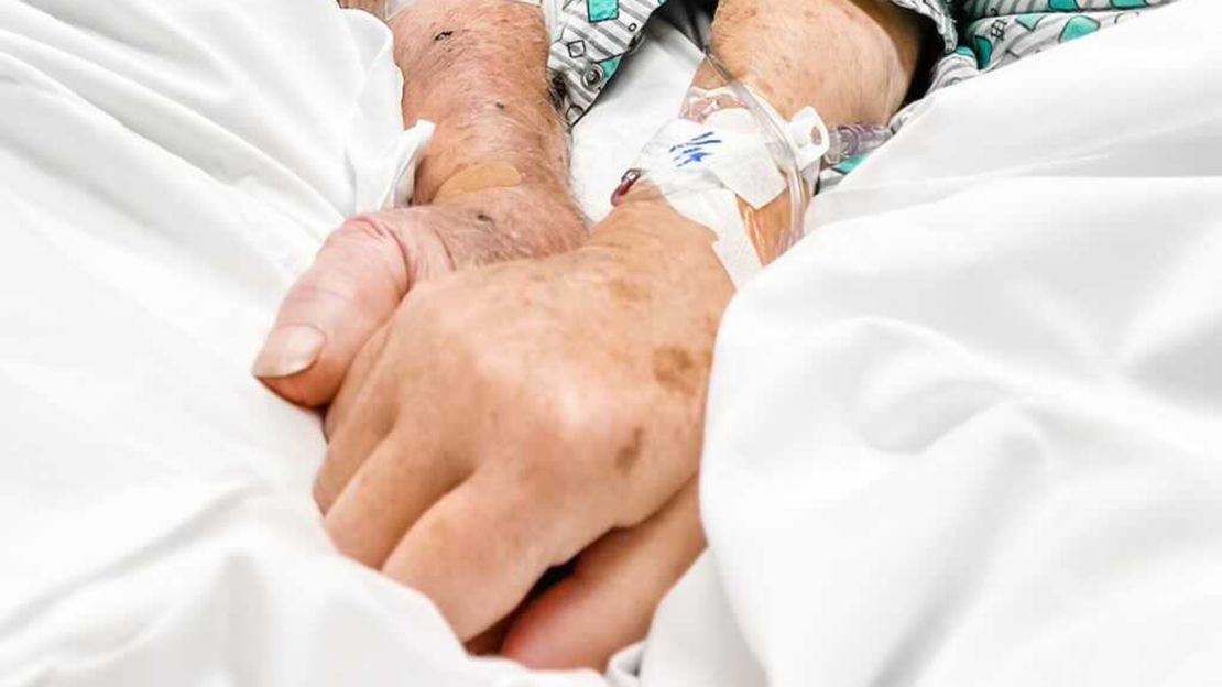 Photo taken at the hospital of Dick and Shirley holding hands before they died.