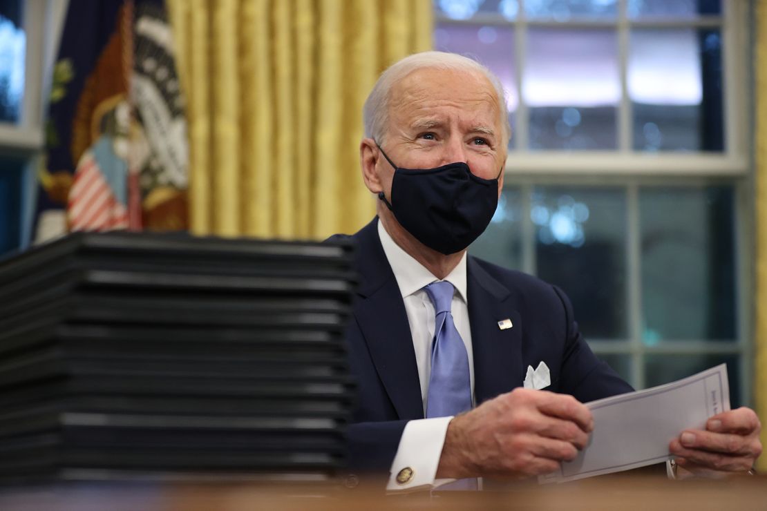 U.S. President Joe Biden prepares to sign a series of executive orders at the Resolute Desk in the Oval Office just hours after his inauguration on January 20, 2021.