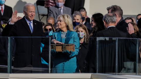 Biden raises his right hand as he takes the oath of office.