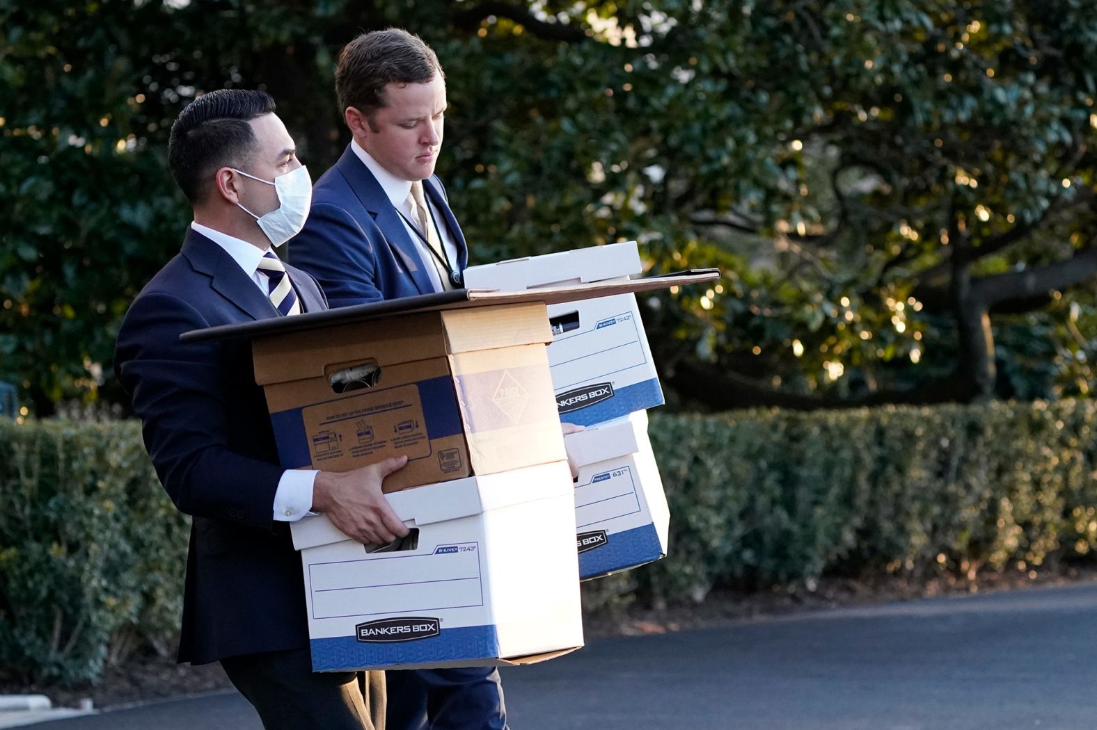 White House staff members carry boxes to Marine One before Trump left the White House.