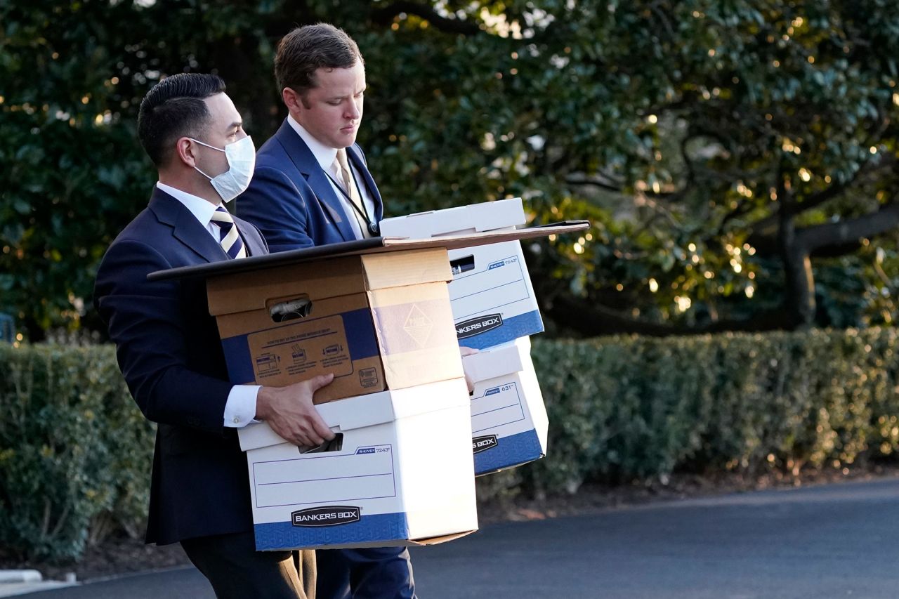 White House staff members carry boxes to Marine One before Trump left the White House.