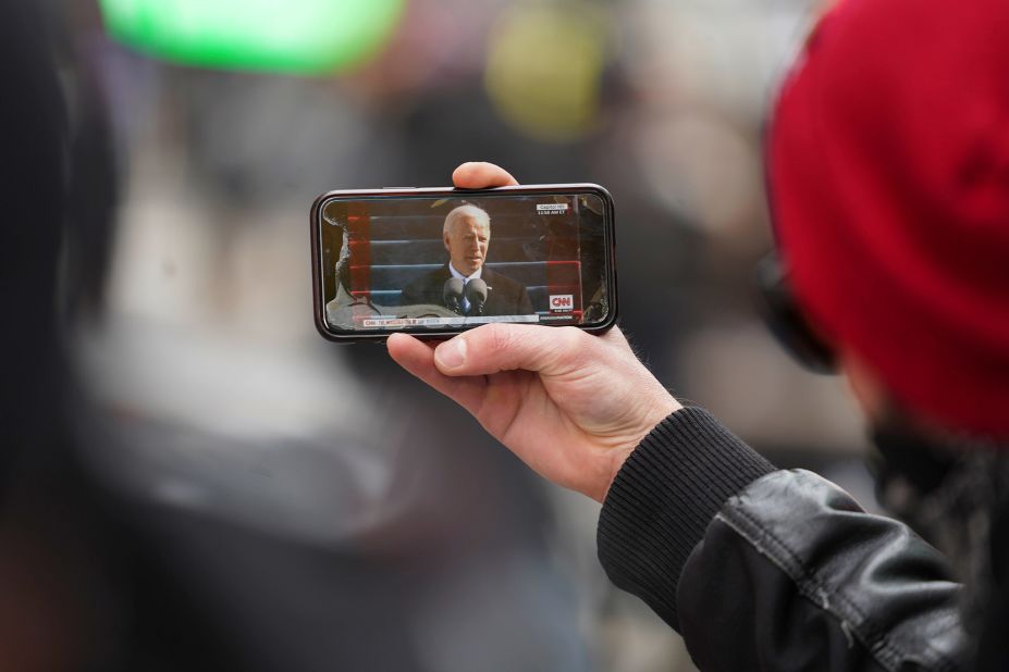 A man watches a live broadcast of the inauguration from Times Square in New York.