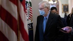 Senate Minority Leader Mitch McConnell, a Republican from Kentucky, wears a protective mask while walking to his office from the Senate Chamber at the U.S. Capitol in Washington, D.C., U.S., on Thursday, Jan. 21, 2021. President Joe Biden is seeking to wipe away Donald Trump's fingerprints from U.S. policy, but his predecessor left lasting partisan divisions in Washington that pose a risk to getting the new presidents agenda through Congress. Photographer: Stefani Reynolds/Bloomberg via Getty Images