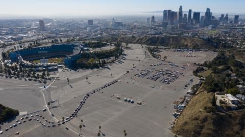 People wait in vehicles at a Covid-19 vaccination site in the Dodger Stadium parking lot in Los Angeles, California, U.S., on Friday, Jan. 15, 2021. (Photographer: Bing Guan/Bloomberg via Getty Images)