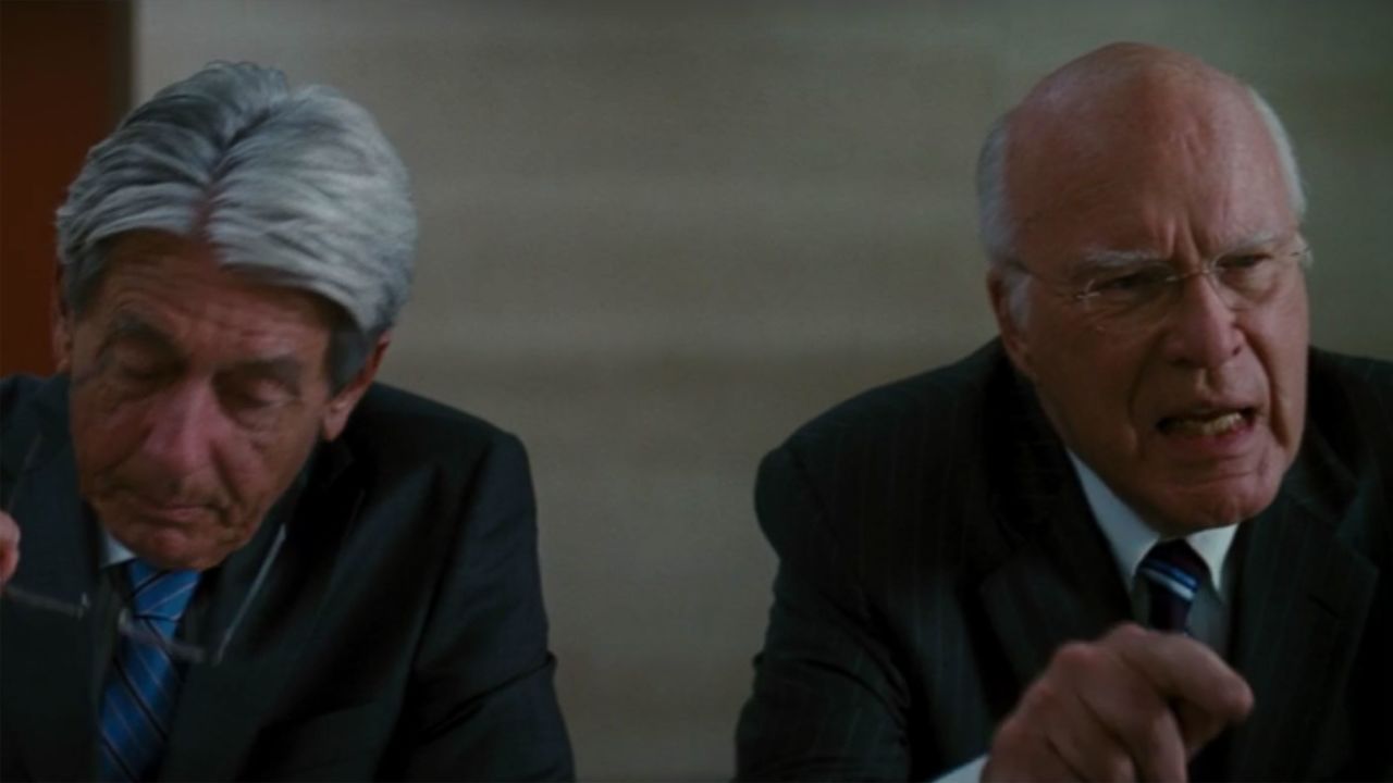 Leahy, scowling, berates someone off-screen in his role as a board member of Wayne Enterprises in "The Dark Knight Rises."